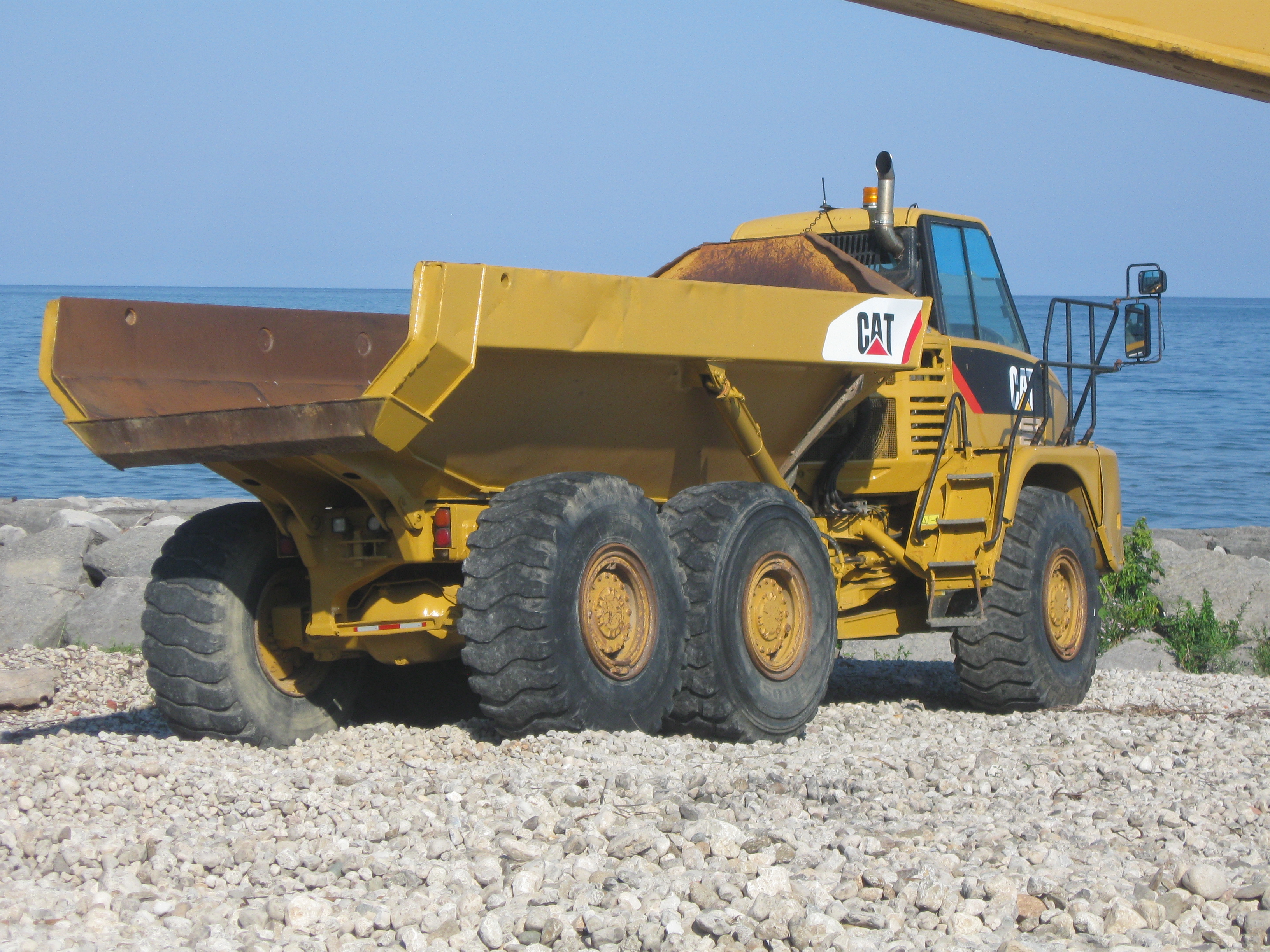 a large dumptruck on the beach of rouge hill